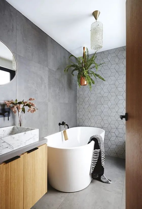 a lovely bathroom with a geometric accent wall