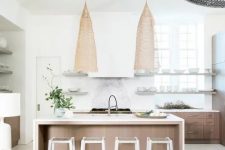 a contemporary coastal kitchen with stained cabinets, a large wooden kitchen island, statement wicker lamps, wooden beams and wicker chairs