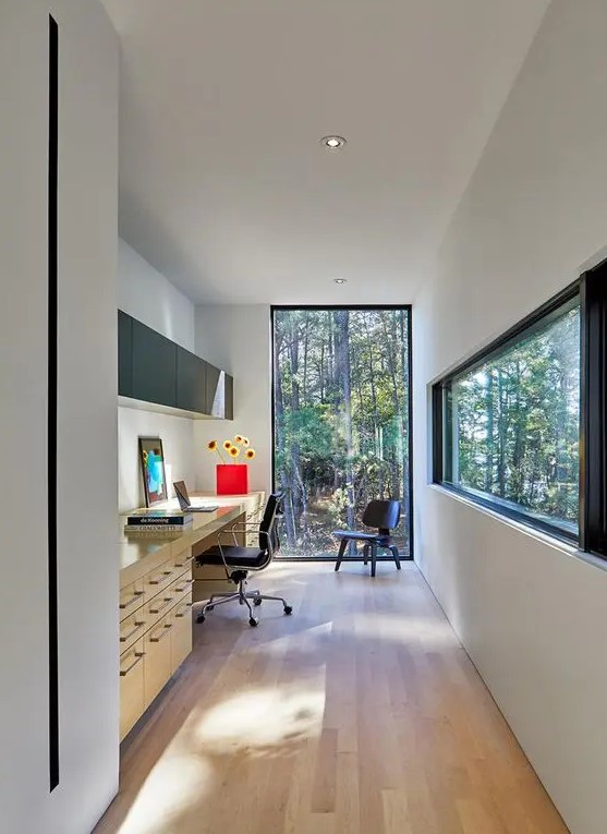 a contemporary home office with windows for amazing views, a large desk with lots of storage compartments, a sleek black storage unit