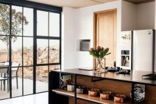 a contemporary kitchen with a large black metal kitchen island with open shelves is a cool idea for displaying beautiful tableware