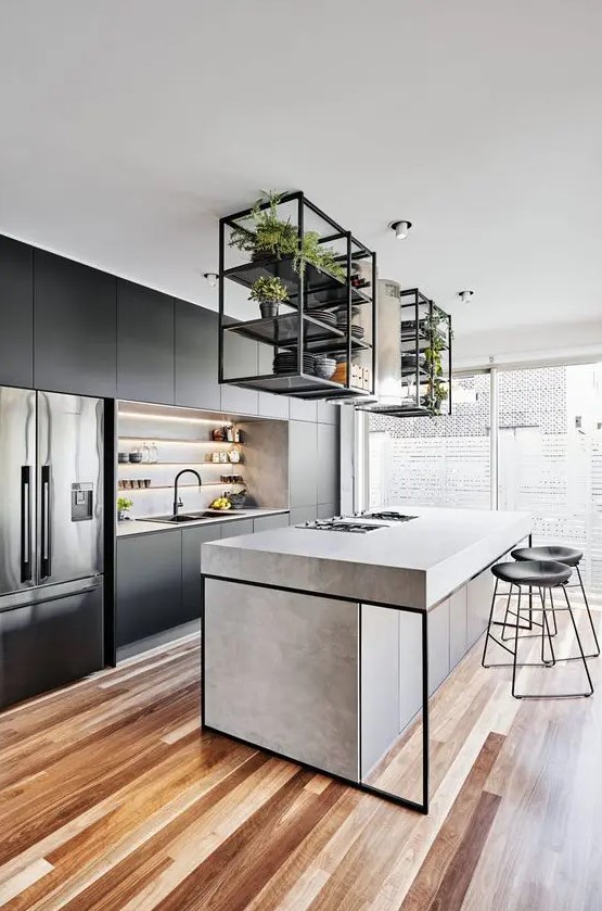 a contemporary kitchen with sleek black cabinets, a concrete kitchen island, black framing, black stools and built in lights