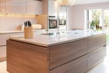a contemporary kitchen with sleek white cabinets and a rich-stained kitchen island, a sleek white countertop and a backsplash