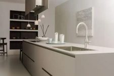 a contemporary to minimalist kitchen done in greige, with a sleek kitchen island, a hood, pendant lamps, niche shelves is amazing