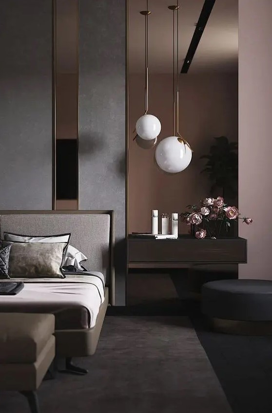 a dreamy contemporary bedroom with an accent wall done with dark mirrors, a chic bed, a leather ottoman, a floating nightstand and a round ottoman