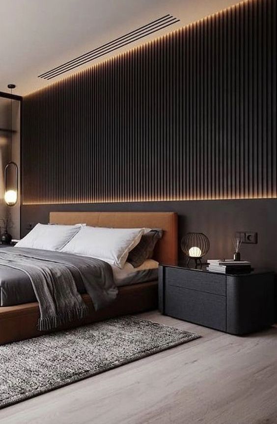 a gorgeous contemporary bedroom with a black wooden slat wall, a rust upholstered bed, black nightstands and lights