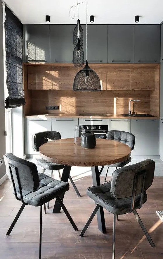 a gorgeous contemporary kitchen with grey and rich-stained cabinets, a matching stained wood backsplash and countertops, a cluster of pendant lamps over the dining space