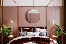 a gorgeous glam bedroom with pink color block walls, a brass bed, a cool chandelier, greenery in pots and parrot pendant lamps