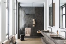 a large contemporary bathroom with a stained floor, a large double vanity, a black shower space and black fixtures wows