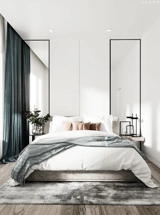 a light filled contemporary bedroom with tall mirrors, floating nightstands, a bed with neutral bedding and green curtains is pure chic