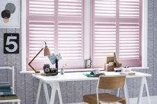 a lovely working space made more feminine with pink shutters that bring a touch of color to the room