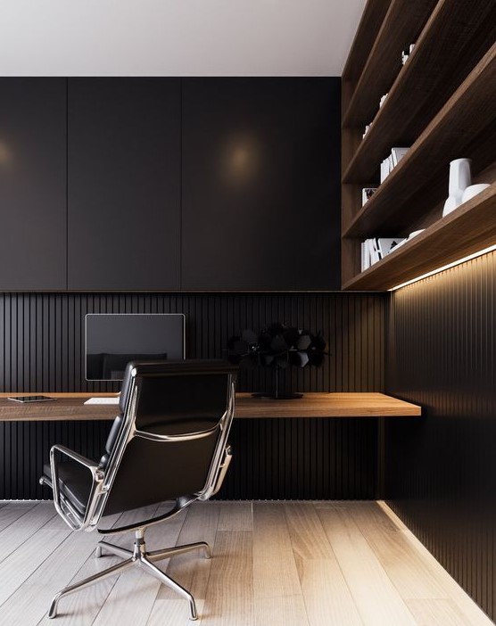 a minimalist masculine home office with an open shelving unit with lights, a floating desk, sleek black cabinets for storage