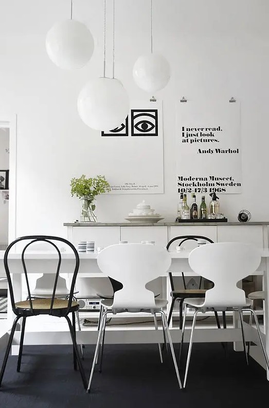 a stylish dining space with a gallery wall