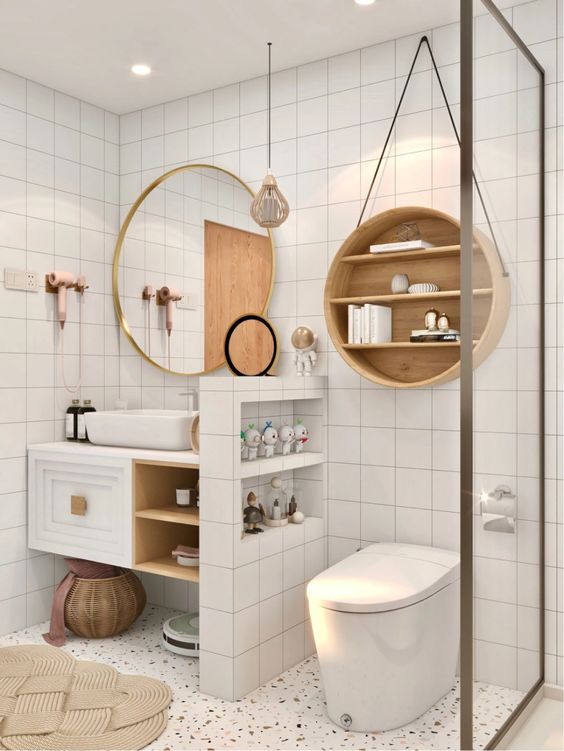 a modern clean bathroom clad with white square tiles, with a terrazzo floor, a half wall as a storage unit and a space divider