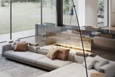 a neutral luxurious living room with a large sectional, a glass fireplace, a table, a daybed is a fantastic lounge zone