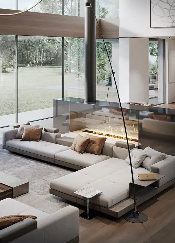 a neutral luxurious living room with a large sectional, a glass fireplace, a table, a daybed is a fantastic lounge zone