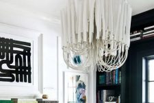 a refined white ceiling medallion paired with an absolutely jaw-dropping modern chandelier with long white bulbs