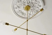 a refined white ceiling medallion to accent a stylish mid-century modern gold ray chandelier with bulbs for a stylish modern room