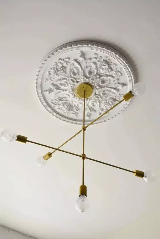 a refined white ceiling medallion to accent a stylish mid-century modern gold ray chandelier with bulbs for a stylish modern room