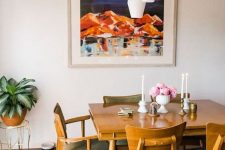 a stylish mid-century modern dining room with a stained table and matching chairs, a cluster of pendant lamps and candles