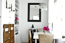a tiny glam dining space with a white table, woven chairs, a jar chandelier and some fuchsia blooms for decor