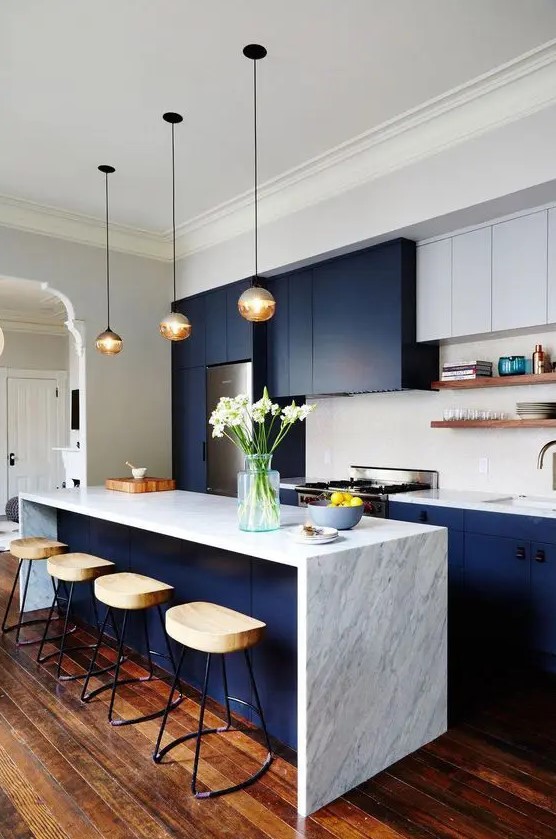 a two tone contemporary kitchen with navy and white cabinets, white stone countertops and a tile backsplash plus open shelves