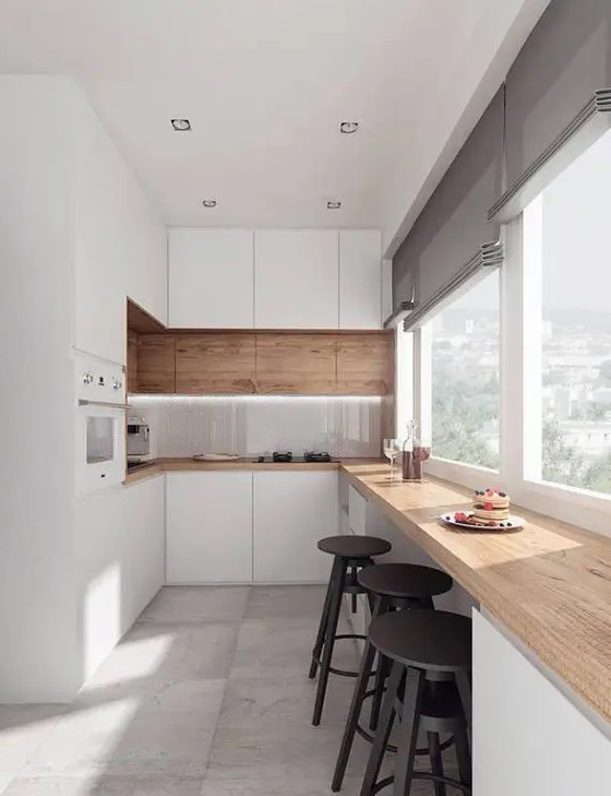 a welcoming contemporary kitchen with sleek white cabinets, a row of stained ones and a matching butcherblock countertop, a meal space by the window