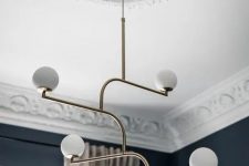 a white patterned ceiling medallion and a modern brass chandelier with bulbs are a lovely pair to rock, they will make your space ultimate