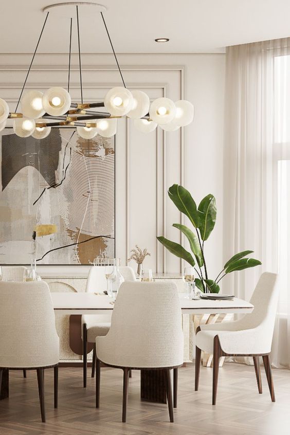 an elegant and sophisticated creamy dining room with a large table and lovely chairs on wooden legs, a bubble chandelier and a large artwork