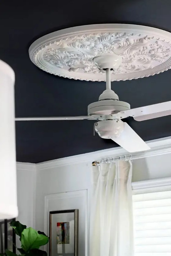 an oversized white ceiling medallion and a white fan that doesn't distract attention from the medallion