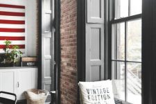 red brick walls look very nice with black solid shutters adding that chic feel to the space and a touch of contrast