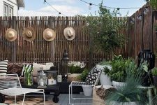 02 a backyard deck styled with string lights over the space and some candle lanterns on the deck is very welcoming and chic