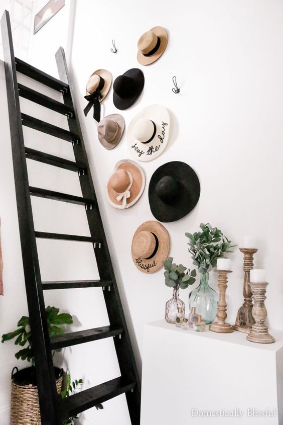 a hat gallery wall over the ladder gives interest and cuteness to the space, it makes the nook catchy
