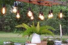10 a quirky outdoor dining space with simple wooden furniture and a catchy ladder chandelier with bulbs is wow