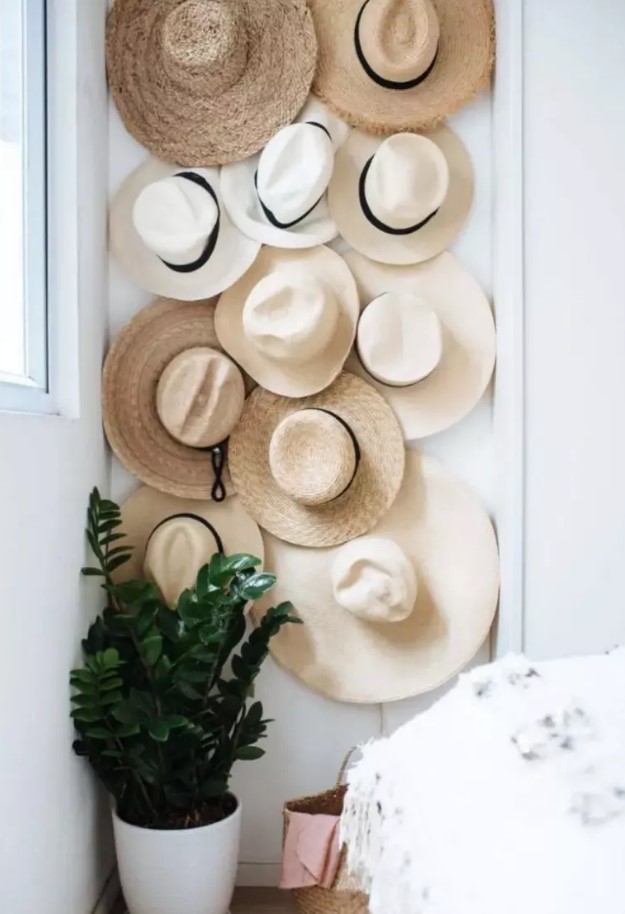 a hat wall that takes an awkward nook in your bedroom is a cool way to fill in the space and to display your beautiful hats at their best