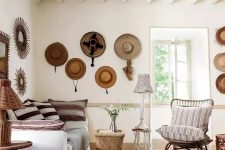 15 a Mediterranean space with neutral decor, wooden and rattan items, hats on the wall that add coziness and interest to the space
