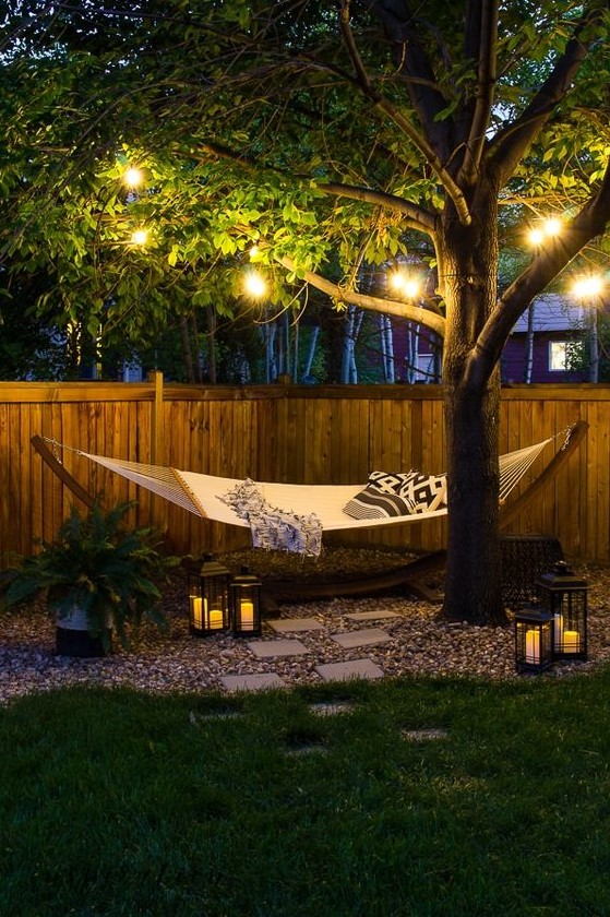 string lights and candle lanterns make this space more welcoming and cozy and accent it a lot