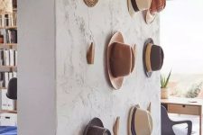 23 a textural wall with wooden hooks from IKEA is a pretty solution to hold your hats, it’s a pretty solution for displaying hats