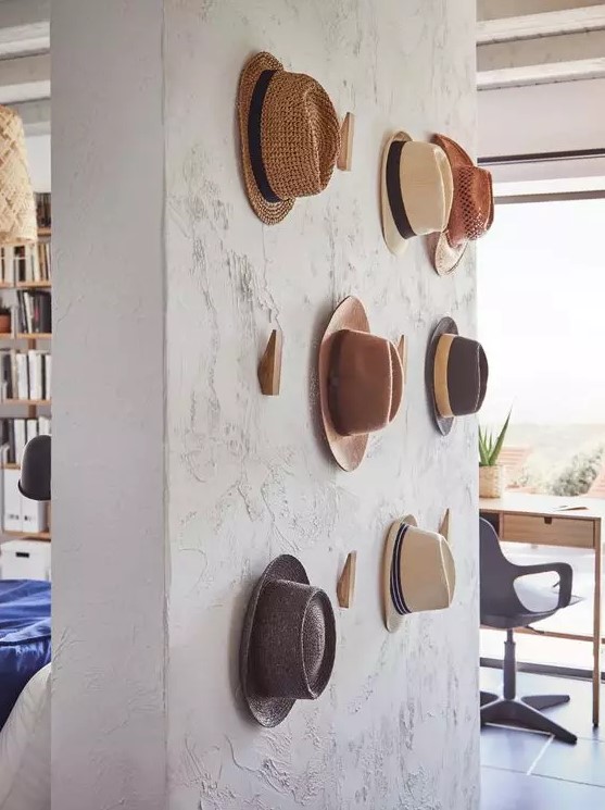 a textural wall with wooden hooks from IKEA is a pretty solution to hold your hats, it's a pretty solution for displaying hats