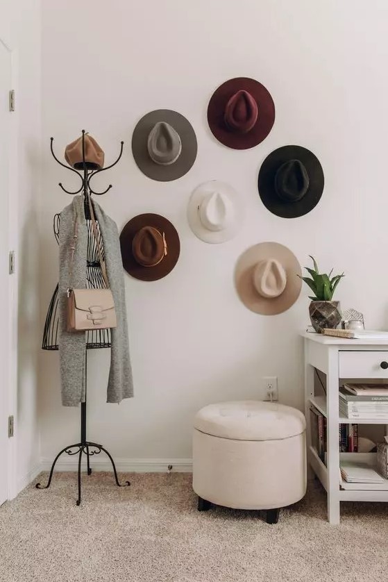 an entryway hat display with hooks on the walls that are hidden by the hats themselves is a lovely idea to add decorative value to the space