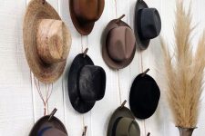 28 an industrial hat display of stained wood, rope and clothespins is a simple and lovely idea for a rustic or industrial space