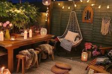 32 a relaxed and welcoming boho backyard with paper and string lights, with candles and candle lanterns