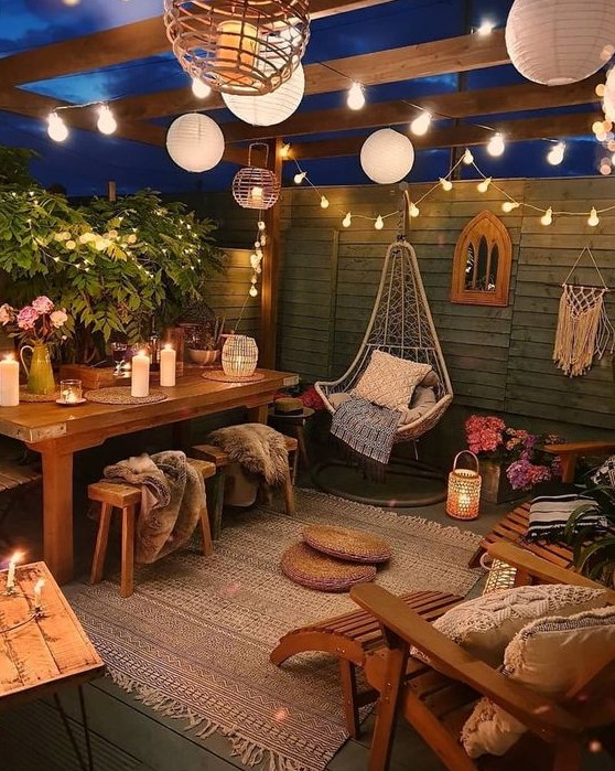 a relaxed and welcoming boho backyard with paper and string lights, with candles and candle lanterns