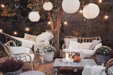 35 a welcoming backyard with candle lanterns, string lights over the space and paper lamps is amazing and cozy