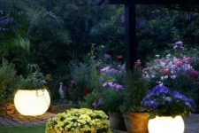 39 lit up planters with blooms are a very creative way to light up your garden and bring a decorative value at the same time