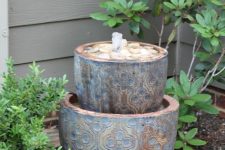 a beautiful small garden fountain of a couple of bowls with Moroccan patterns and pebbles in the upper one is amazing