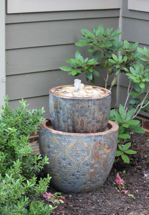 a beautiful small garden fountain of a couple of bowls with Moroccan patterns and pebbles in the upper one is amazing