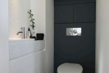 a black and white contemporary powder room with a built-in sink, some built-in lights and even storage