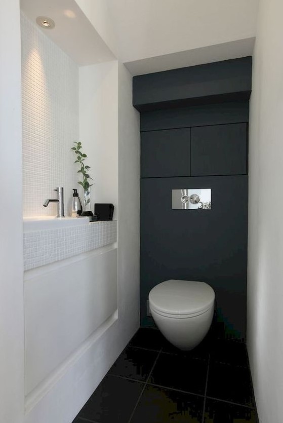 A black and white contemporary powder room with a built in sink, some built in lights and even storage