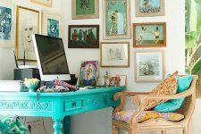a bright eclectic home office nook with a vintage turquoise desk, a refined stained chair, a bright gallery wall and a colorful rug