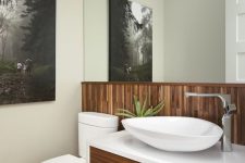 A small bathroom with a wood wall